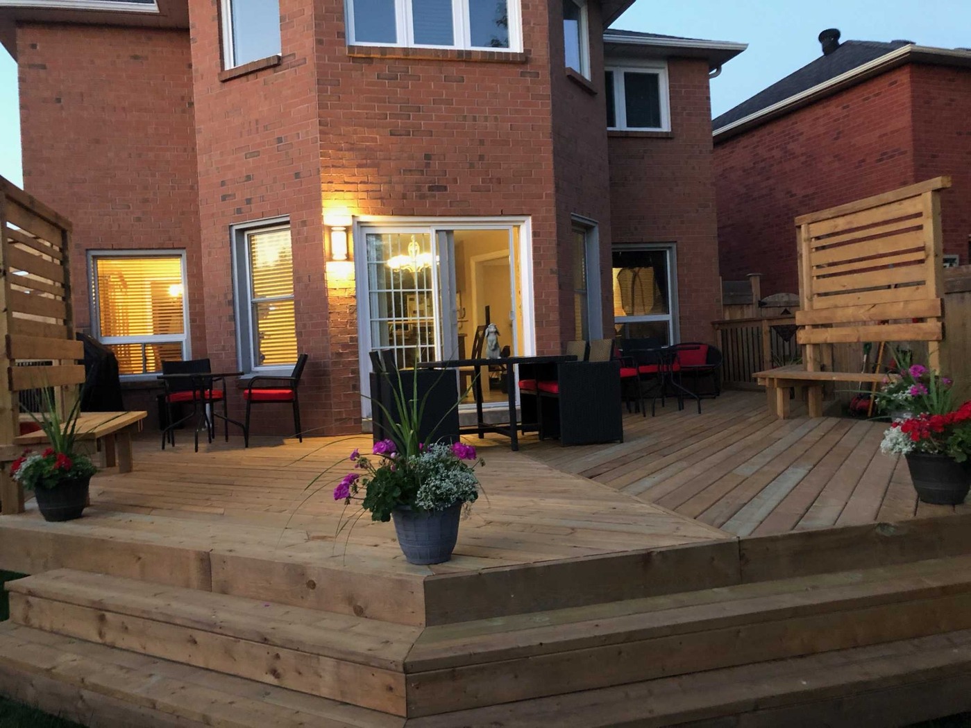 Large backyard deck with seating and planters