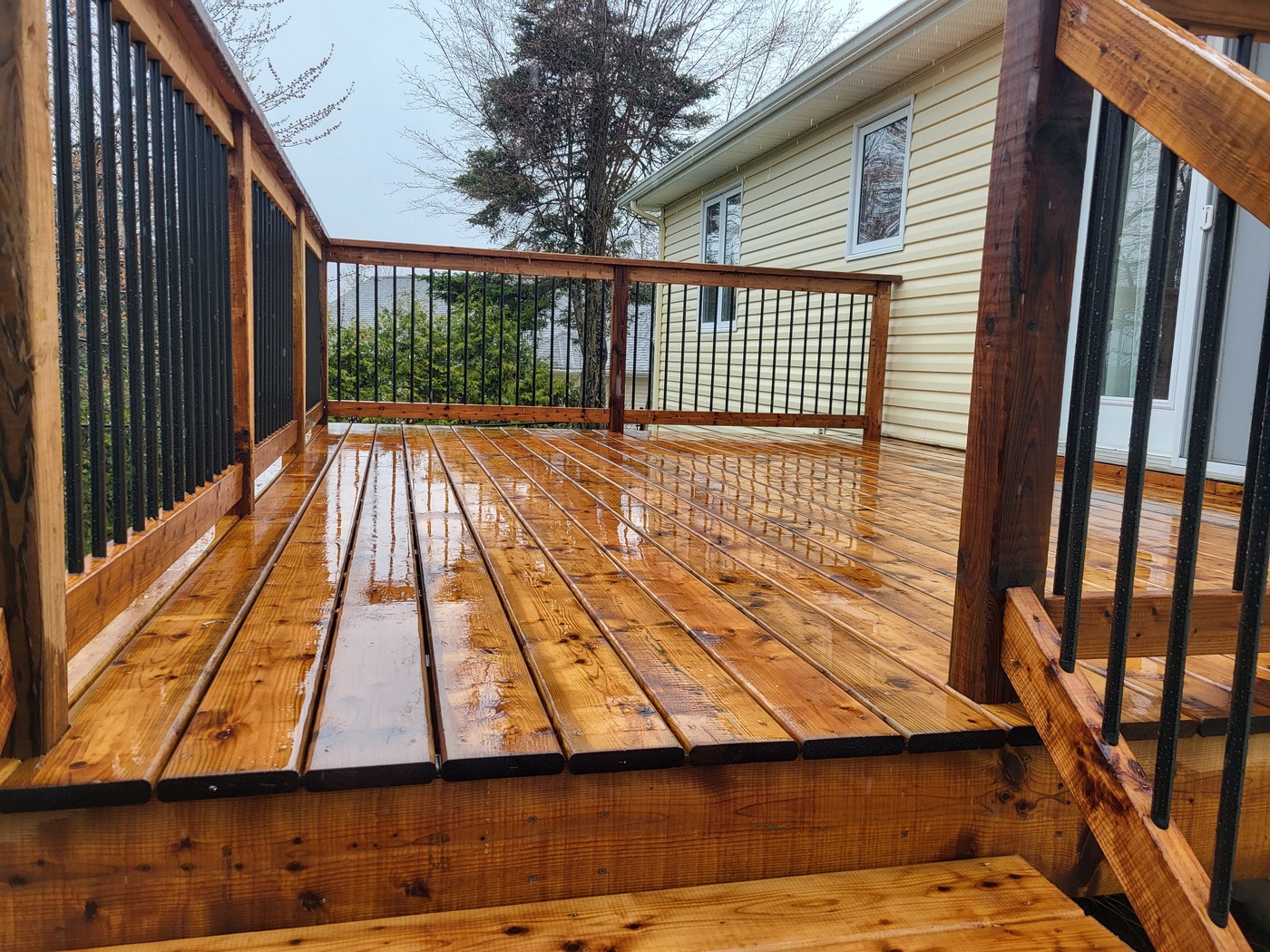 Refinished wood deck surface after rain