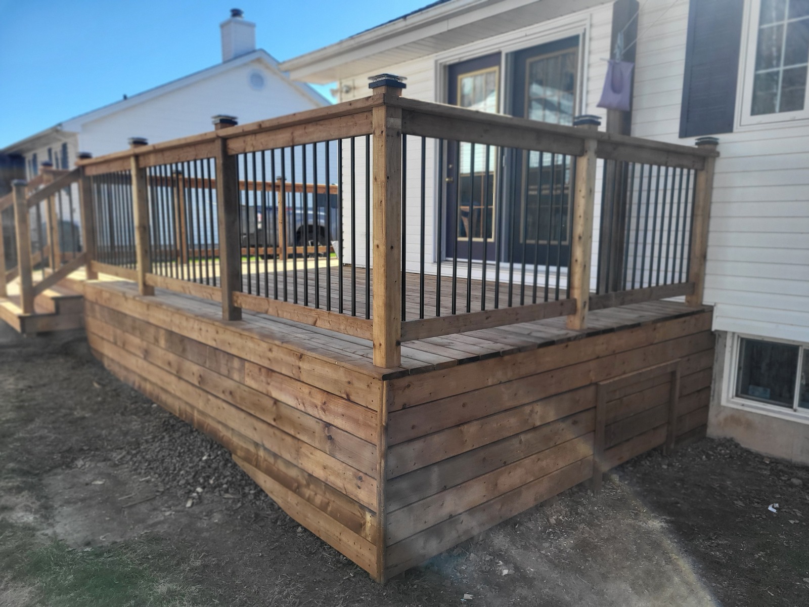Finished raised wood deck with black railings